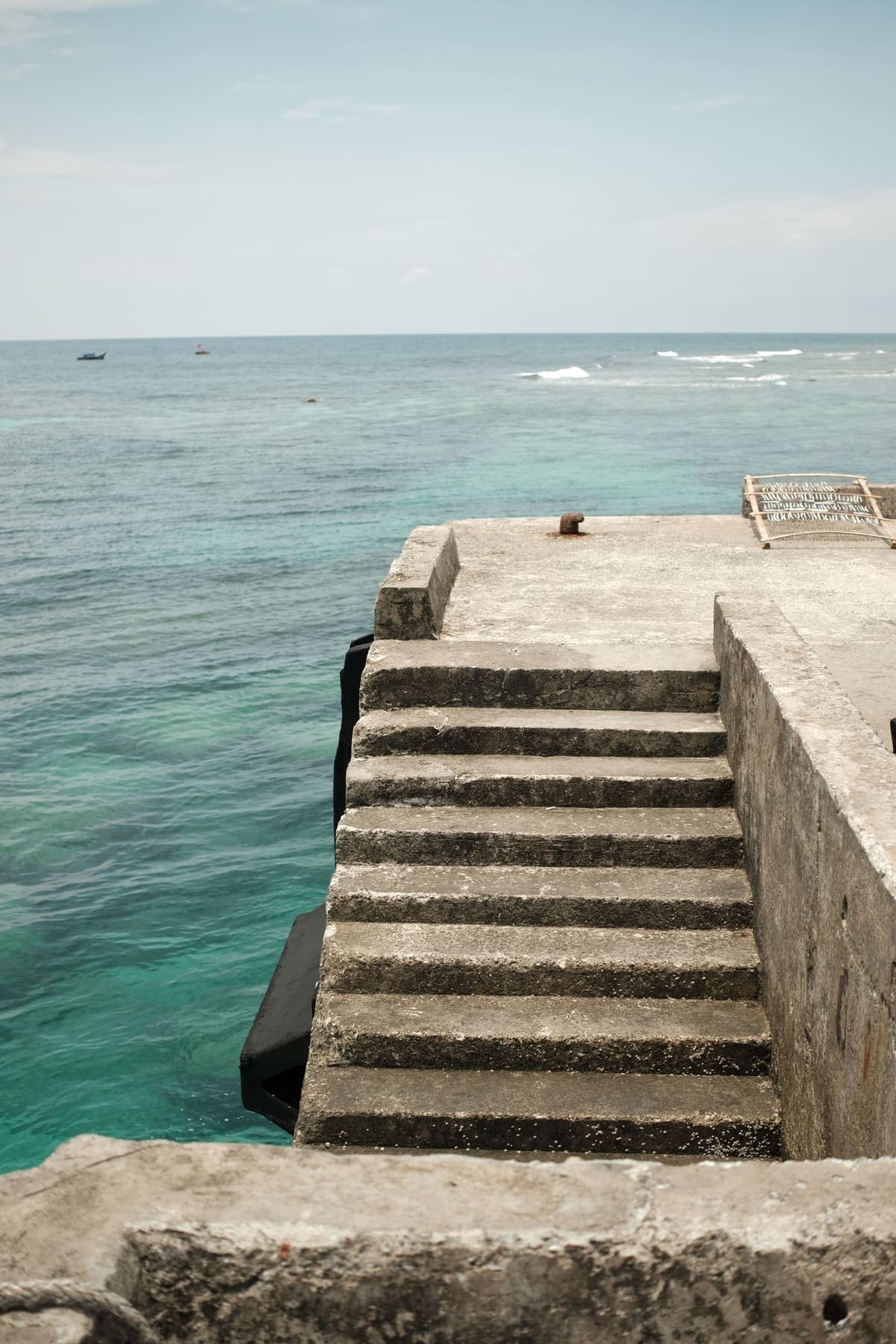 Concrete steps leading down into clear blue water