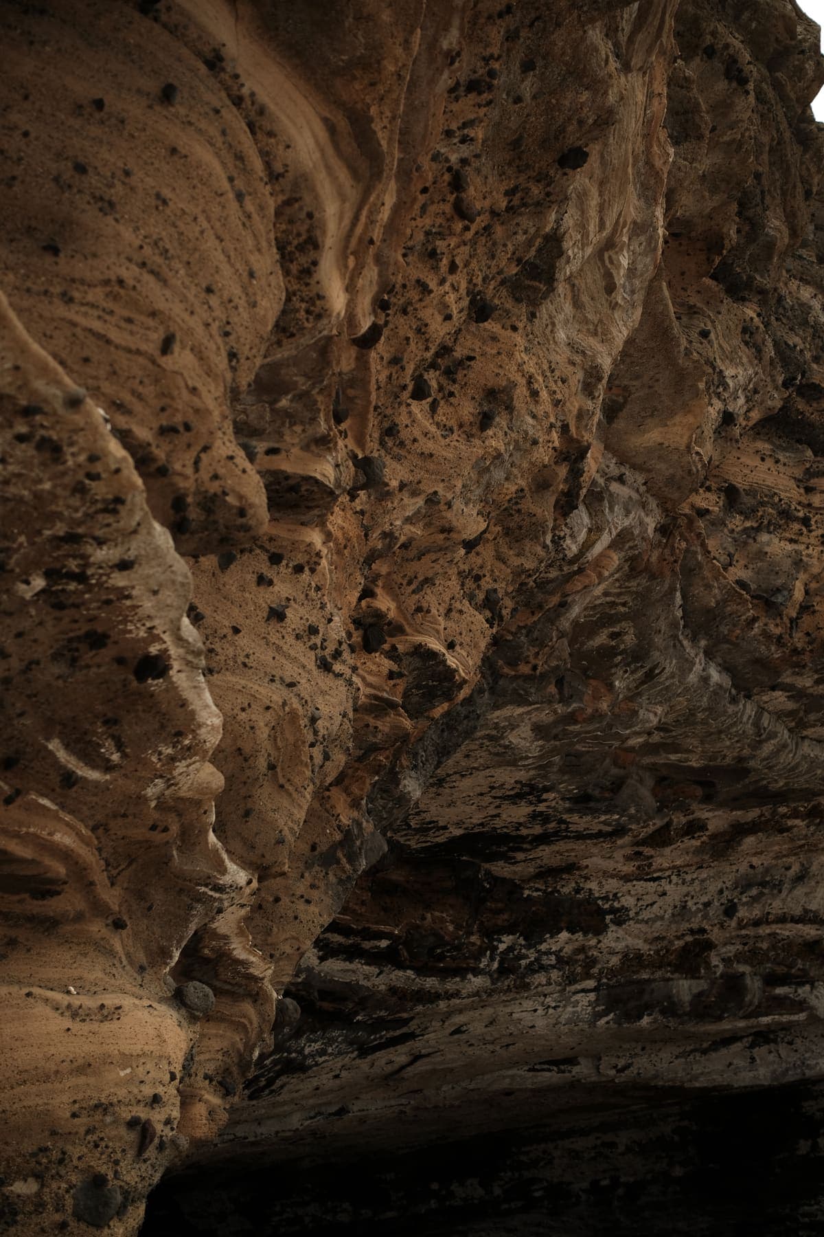Close-up of weathered, pitted sandstone in a sea cave